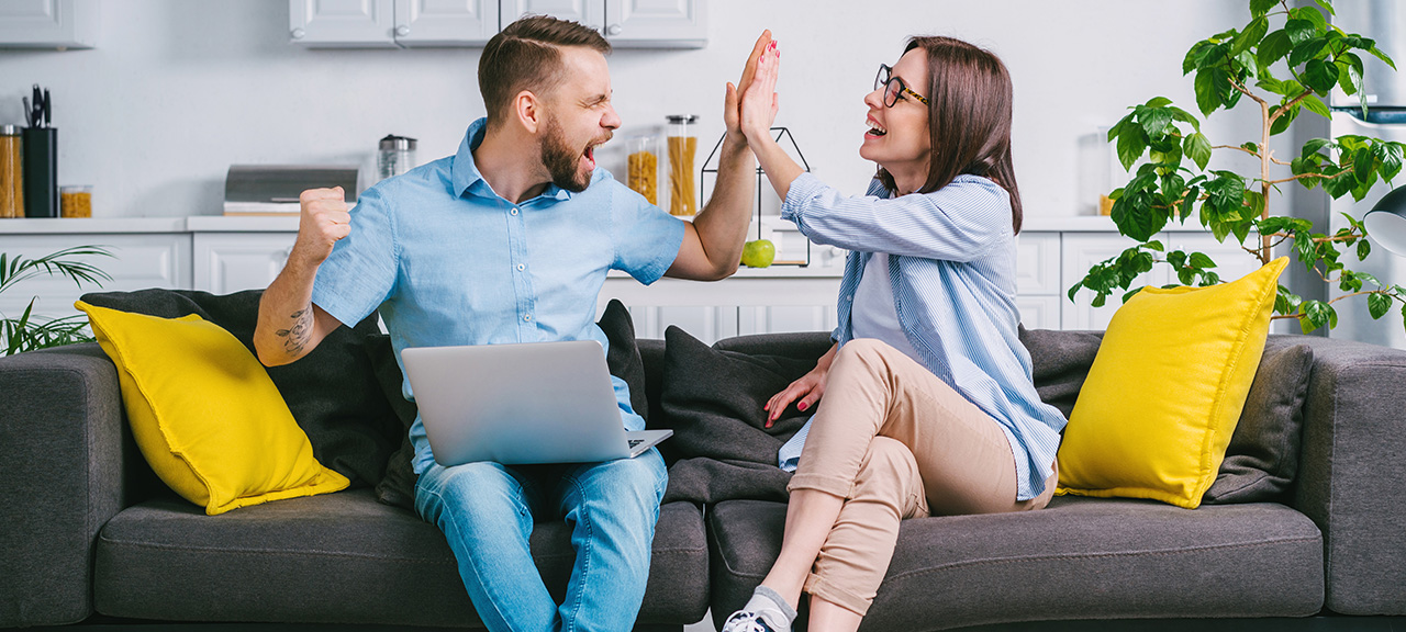 An excited couple on a couch